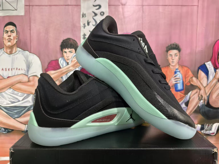 Black and mint green Jordan basketball sneakers displayed on a box, shown from the side and upper angle.