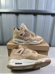 Pair of tan Jordan Air Jordan 4 Retro sneakers shown on and beside a shoebox.