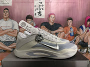Side profile of a white and grey Nike basketball sneaker with a metallic silver Swoosh and contrasting grey side accents.