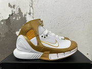 Side profile of a white and metallic-gold Nike Zoom 2K5 shoe.