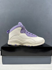 Side profile of a single white and purple high-top sneaker displayed on a shoebox.