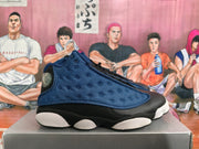 Side profile showing the textured deep blue panel and segmented outsole