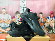 Black Nike basketball shoes shown from the side and at an angle