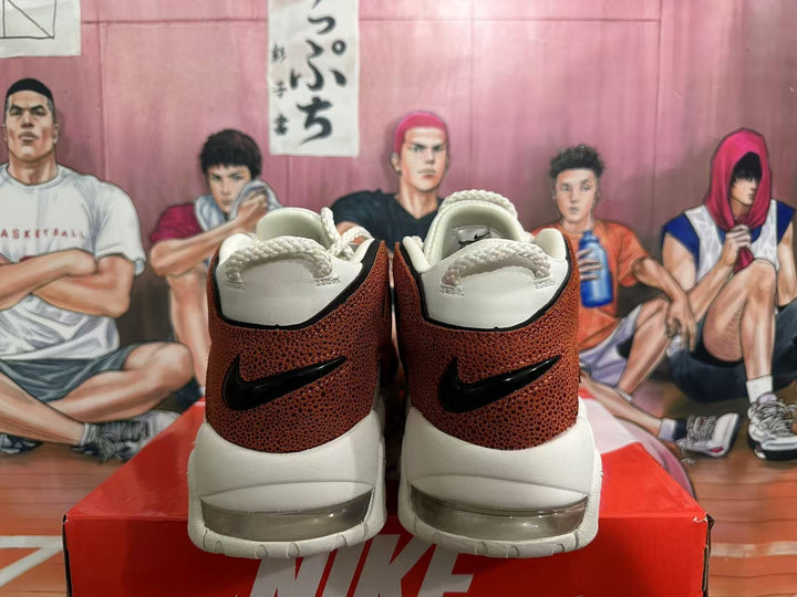 Rear view of off-white and brown Nike basketball sneakers with rope-style heel loops and visible cushioning windows.