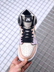 Top-down view of the sneaker showing the perforated toe panel, black laces, padded tongue, and pastel overlays.