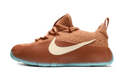 Brown James TR1 sneaker with a cream side mark and turquoise outsole edge.