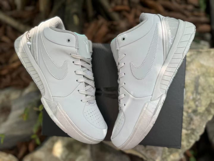 Pair of white Nike Kobe 4 shoes shown from the sides