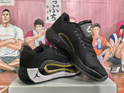 Angled view showing the pair of black Jordan basketball sneakers and their layered side detailing.