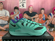 Side profile of a gray-green Nike sneaker with layered upper panels, black mesh inserts, and a black outsole.