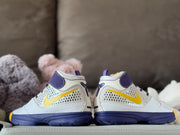 Rear view of the pair showing the purple heel overlays, white collars, and dark purple outsoles.