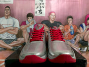 Front view showing the perforated silver toe panels, red laces and red outsole.