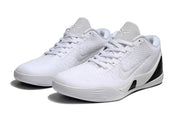 Pair of all-white low-top shoes shown from the front.
