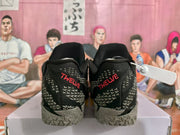 Rear view of black Nike basketball shoes with red TWELVE heel lettering