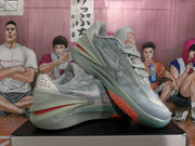 Pair of gray Nike basketball sneakers shown at an angle, highlighting the layered upper, laces, and contrasting outsole.