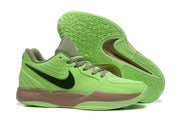 Bright green basketball shoes shown with patterned outsole tread and tan midsole sections.