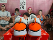 Rear view showing orange heel panels, white padded collars, and orange outsole details
