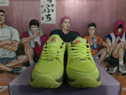 Front view of lime green Nike basketball sneakers with matching laces and textured toe boxes.
