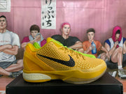 Yellow Nike basketball shoe with a textured upper, black Swoosh, and Zoom branding on the midsole.