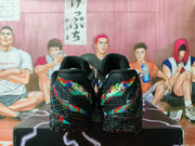 Rear view of the black Nike sneakers showing multicolor heel panels and textured black outsoles.