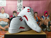 Angled view of white Jordan high-top sneakers showing red eyelets and side details.