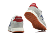 Rear and outsole views highlighting the red heel tabs and gum-colored tread.