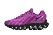 Side view of a purple Nike Air Max DN 8 sneaker with black cushioning sole.