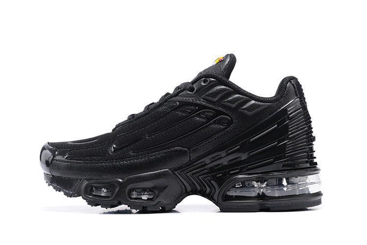 Black Nike Shox TL sneaker shown from the side, with layered panels and visible sole cushioning.