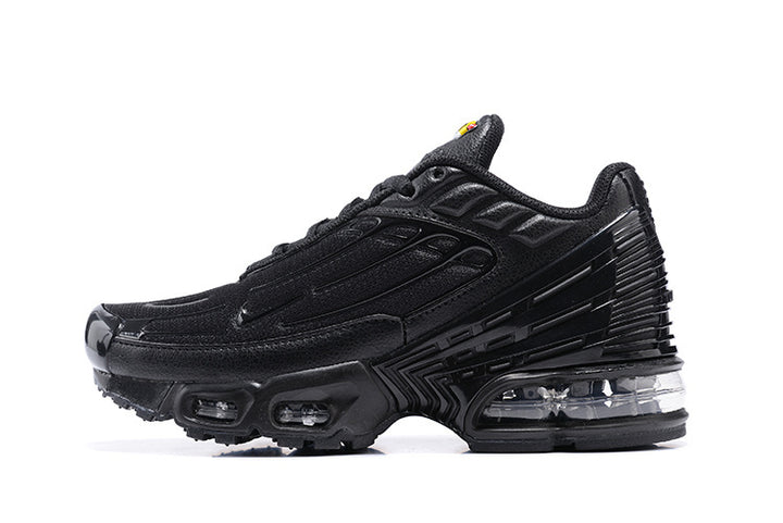 Black Nike Shox TL sneaker shown from the side, with layered panels and visible sole cushioning.