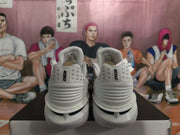Rear view showing Nike branding on the heel of white basketball shoes.