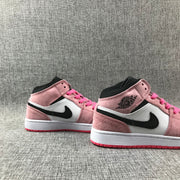 Pair of pink, white and black mid-top sneakers photographed from the outer sides.