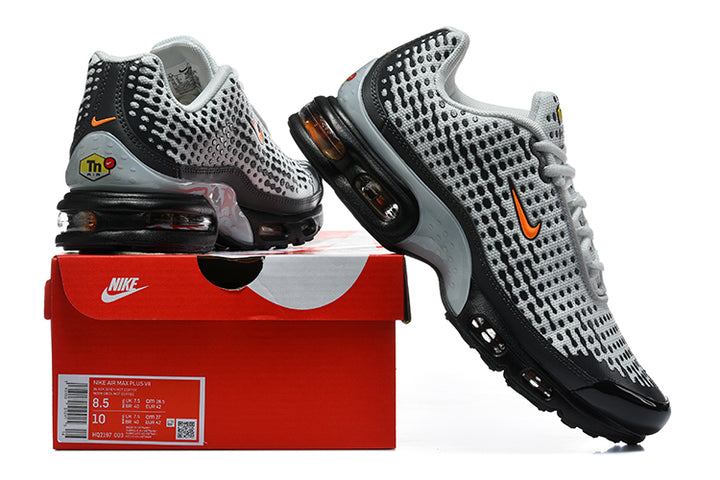 Grey and black Nike Air Max Plus VII sneakers displayed with a red Nike shoebox; the box label shows size 8.5 and 10.