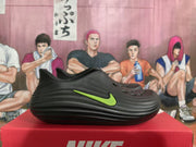 Side view of a black Nike sneaker with a bright volt-green Swoosh and sculpted layered sidewall.