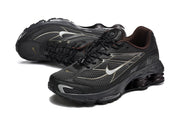 Angled view of a pair of black Nike Shox Ride 2 sneakers with mesh panels and layered side detailing.