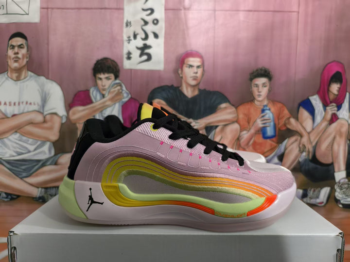 Side view of a Jordan basketball sneaker in pink, black, lime, white and orange, displayed on a shoebox.