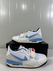Close three-quarter view showing perforations on the toe, layered upper panels, blue Swoosh and forefoot strap.