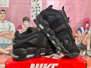 Angled view of paired black Nike sneakers highlighting the high-top construction, layered side panels, and transparent cushioning sections.