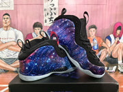 Pair of purple and blue starry high-top basketball sneakers displayed on a shoebox.