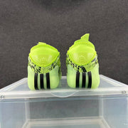 Rear view of lime-green sneakers showing black vertical sole accents