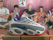 Side profile of a white Nike sneaker showing a blue side logo, black-and-white patterned panel, sculpted sole, and red outsole edge.