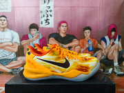 Side profile showing the black Swoosh, orange heel, and patterned upper.