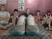 Front view of white and grey basketball sneakers showing textured uppers, white laces and blue translucent outsoles.