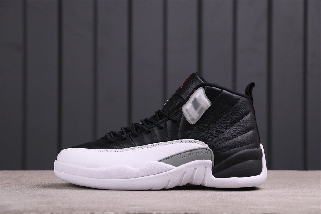 Side view of black and white Jordan Air Jordan 12 high-top sneakers with a grey Jumpman panel.