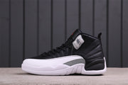 Side view of black and white Jordan Air Jordan 12 high-top sneakers with a grey Jumpman panel.