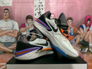 Angled view highlighting the patterned heel panels, side branding, and layered purple and orange sole details.