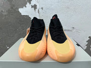 Front view of black Adidas AE 1 high-top basketball shoes with pale yellow toe panels and peach-orange soles.