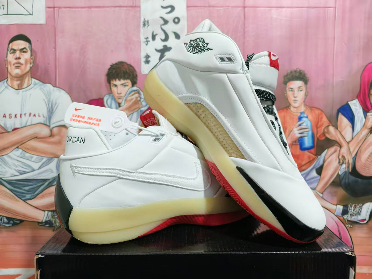 White Jordan low-top basketball shoes with black and red details, shown from the side and rear.