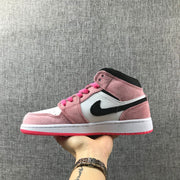 Side profile of the pink, white and black mid-top sneaker.