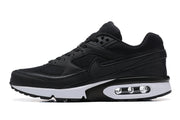 Side profile of a black Nike Air Max sneaker with a white midsole and visible air unit.