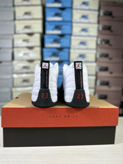 Rear view of a pair of white, black and red Jordan high-top sneakers showing Jordan branding and the number 23.