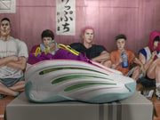 Side view showing green inset accents on the white shoe upper
